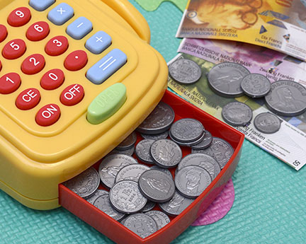 Toy cash register with play money and coins