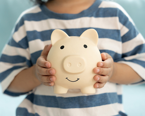 Child holding a piggy bank