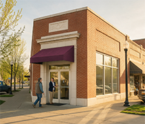 Customer talking with a community banker outside a local branch