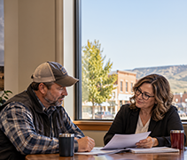 Community banker reviewing business plans with a customer